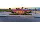 A well-manicured estate featuring lush landscaping and a charming exterior with a red tile roof at 10280 W La Mancha Ave, Las Vegas, NV 89149