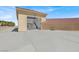 Large garage with red tile roof, huge vehicle doors, and parking for multiple cars at 10280 W La Mancha Ave, Las Vegas, NV 89149