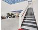 Staircase leads to the upper level inside a large garage, with custom ceiling art at 10280 W La Mancha Ave, Las Vegas, NV 89149