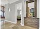 Hallway with view into main bedroom that has bed with green comforter at 10280 W La Mancha Ave, Las Vegas, NV 89149