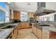 Kitchen with granite counters, stainless steel appliances, and a large vent hood at 10280 W La Mancha Ave, Las Vegas, NV 89149