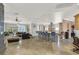 Spacious living room and kitchen area with center island and bar seating and tile flooring at 10280 W La Mancha Ave, Las Vegas, NV 89149