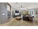 Living room featuring a stone fireplace, tile flooring, and large screen TV at 10280 W La Mancha Ave, Las Vegas, NV 89149