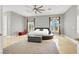 Comfortable main bedroom featuring a neutral color palette, ceiling fan, and sunny windows at 10280 W La Mancha Ave, Las Vegas, NV 89149