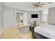 Open main bedroom with sitting area, ceiling fan, and entry to the main bathroom at 10280 W La Mancha Ave, Las Vegas, NV 89149