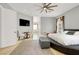 Spacious main bedroom featuring a ceiling fan, sitting area, and large windows at 10280 W La Mancha Ave, Las Vegas, NV 89149