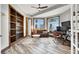 Well-lit home office with built-in shelving, multiple windows, and a comfortable seating area at 10280 W La Mancha Ave, Las Vegas, NV 89149