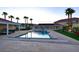 Wide angle view of an in-ground pool with a slide and outdoor seating area in backyard at 10280 W La Mancha Ave, Las Vegas, NV 89149