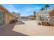 Backyard pool area with covered patio, palm trees, and outdoor seating at 10280 W La Mancha Ave, Las Vegas, NV 89149