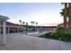 Large pool area with covered patio, palm trees, and landscaped yard at 10280 W La Mancha Ave, Las Vegas, NV 89149