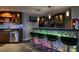 Custom wet bar with granite countertops, seating for four, and plenty of storage at 10280 W La Mancha Ave, Las Vegas, NV 89149