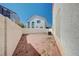 A spacious backyard features a white fence, exterior house wall, and gravel ground cover at 10360 Cherry Brook St, Las Vegas, NV 89183
