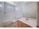 Bright bathroom features a tub/shower, wood-look floors and a large mirror at 10360 Cherry Brook St, Las Vegas, NV 89183