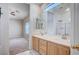 A bathroom features dual sinks and a shower at 10360 Cherry Brook St, Las Vegas, NV 89183
