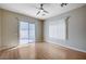 Bedroom with wood floors, a sliding glass door, and a window at 10360 Cherry Brook St, Las Vegas, NV 89183