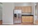 Kitchen with wooden cabinets, stainless steel refrigerator, and hardwood flooring at 10360 Cherry Brook St, Las Vegas, NV 89183