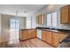 Sunlit kitchen with wooden cabinets, stainless steel sink, and sliding glass door at 10360 Cherry Brook St, Las Vegas, NV 89183