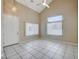 Inviting living room with tile floor, ceiling fan and large windows at 10360 Cherry Brook St, Las Vegas, NV 89183