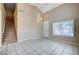 Open-concept living room with tile flooring, staircase, and ample natural light at 10360 Cherry Brook St, Las Vegas, NV 89183