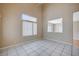 Bright living room with tile floors, large window, and vaulted ceilings at 10360 Cherry Brook St, Las Vegas, NV 89183
