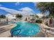 Resort-style pool with rock waterfall feature, lounge chairs, and nearby cabana for relaxing on a sunny day at 10360 Cherry Brook St, Las Vegas, NV 89183