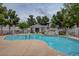 Community pool with rock waterfall feature, seating area, and lush landscaping for a relaxing atmosphere at 10360 Cherry Brook St, Las Vegas, NV 89183