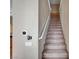 Carpeted staircase with white railing and neutral-colored walls at 10360 Cherry Brook St, Las Vegas, NV 89183