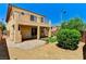 Inviting backyard featuring a spacious patio, small patch of grass and desert landscaping, perfect for outdoor living at 10805 Cain Ave, Las Vegas, NV 89166
