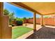 A covered patio featuring brick flooring and a view of the backyard with artificial turf at 10805 Cain Ave, Las Vegas, NV 89166
