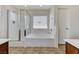 Bathroom features a shower, bathtub, and a window for natural light at 10805 Cain Ave, Las Vegas, NV 89166