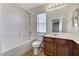 Bright bathroom with a shower-tub combination, modern vanity, and stylish tile flooring at 10805 Cain Ave, Las Vegas, NV 89166