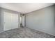 This bedroom features neutral walls, plush carpet, and a large closet with white doors at 10805 Cain Ave, Las Vegas, NV 89166