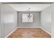 Formal dining area with wood-look floors, a chandelier, and a large window at 10805 Cain Ave, Las Vegas, NV 89166