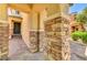 Inviting front porch showcasing stone-clad columns and a beautifully paved walkway to the front door at 10805 Cain Ave, Las Vegas, NV 89166
