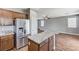 This open concept kitchen features stainless steel appliances and a breakfast bar at 10805 Cain Ave, Las Vegas, NV 89166