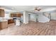Open kitchen and living area featuring wood-look floors, stainless appliances, and bar seating at 10805 Cain Ave, Las Vegas, NV 89166