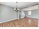 Spacious living area features beautiful wood-look floors and an open layout leading to stairs at 10805 Cain Ave, Las Vegas, NV 89166