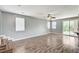 Bright living room with wood-look floors, large windows, and sliding glass doors to the backyard at 10805 Cain Ave, Las Vegas, NV 89166