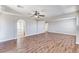 Spacious living room features beautiful wood floors, a ceiling fan, and neutral paint at 10805 Cain Ave, Las Vegas, NV 89166