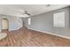 Expansive open-concept living space with wood-look floors and a staircase leading upstairs at 10805 Cain Ave, Las Vegas, NV 89166