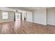 Large living room featuring hardwood flooring and natural light from the sliding glass doors at 10805 Cain Ave, Las Vegas, NV 89166