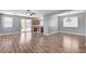 Spacious living room with wood-look flooring, flowing into the kitchen, and patio access at 10805 Cain Ave, Las Vegas, NV 89166