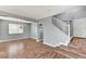 Open-concept living area with wood-look floors, a staircase, and neutral gray walls at 10805 Cain Ave, Las Vegas, NV 89166