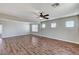 Bright living room boasts wood floors, a ceiling fan, and plenty of natural light at 10805 Cain Ave, Las Vegas, NV 89166