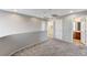 This loft space has neutral carpet, fresh paint, and access to the laundry room and bathroom at 10805 Cain Ave, Las Vegas, NV 89166