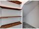 Storage area with wood shelving and carpeted floor, ideal for organization and accessibility at 10805 Cain Ave, Las Vegas, NV 89166