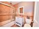 Cozy bathroom features a shower over tub, tiled walls, and modern fixtures at 1112 Sandy Cove St, Las Vegas, NV 89110