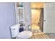 Modern bathroom features a tiled shower, toilet, shelves, and vanity at 1112 Sandy Cove St, Las Vegas, NV 89110
