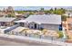 Charming single story home with desert landscaping, white paint and grey trim, palm trees, and mountain views at 1112 Sandy Cove St, Las Vegas, NV 89110