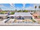 Charming single story home with desert landscaping, white paint and grey trim, palm trees, and mountain views at 1112 Sandy Cove St, Las Vegas, NV 89110